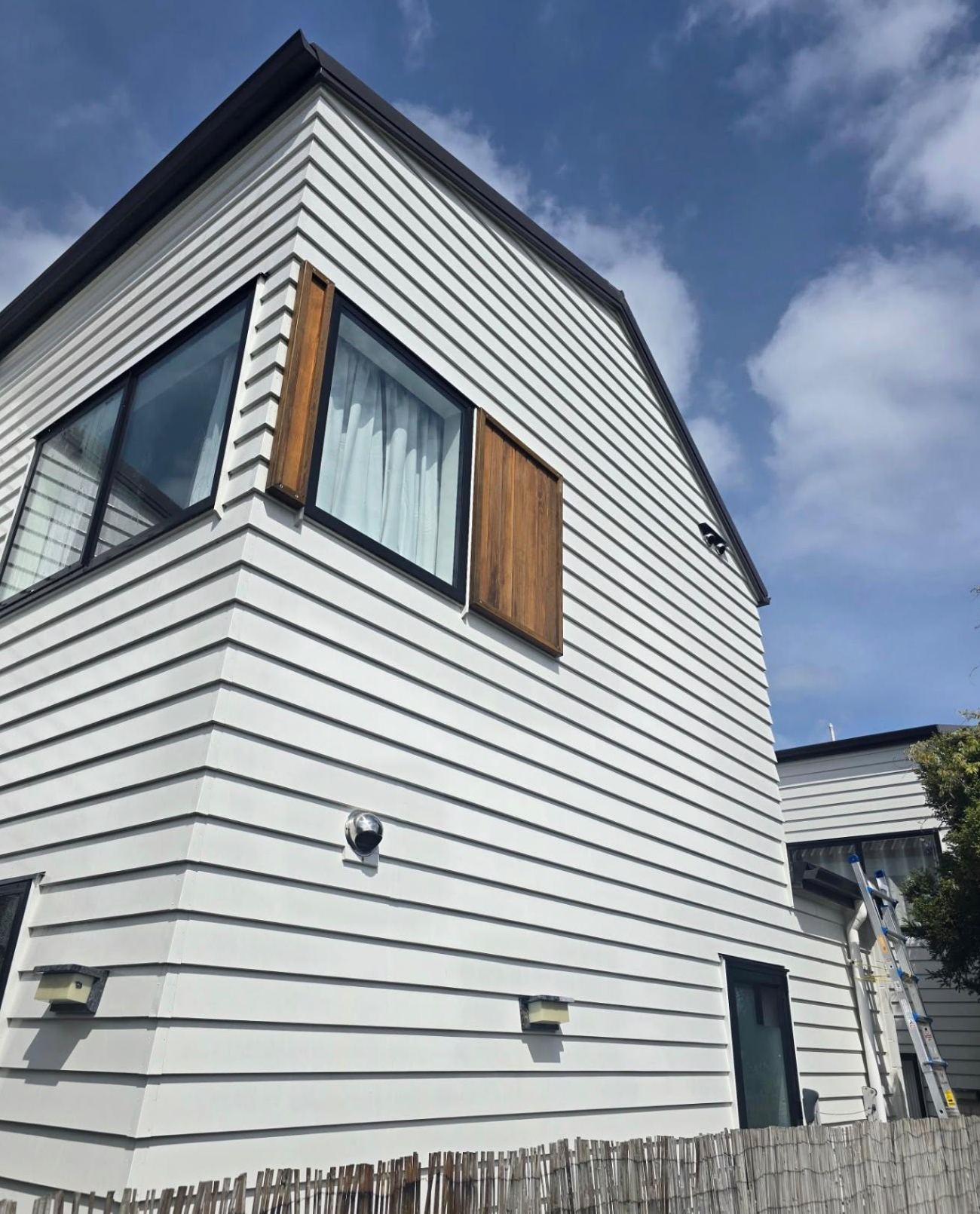 The same North Shore weatherboard home after a soft wash, clean white cladding